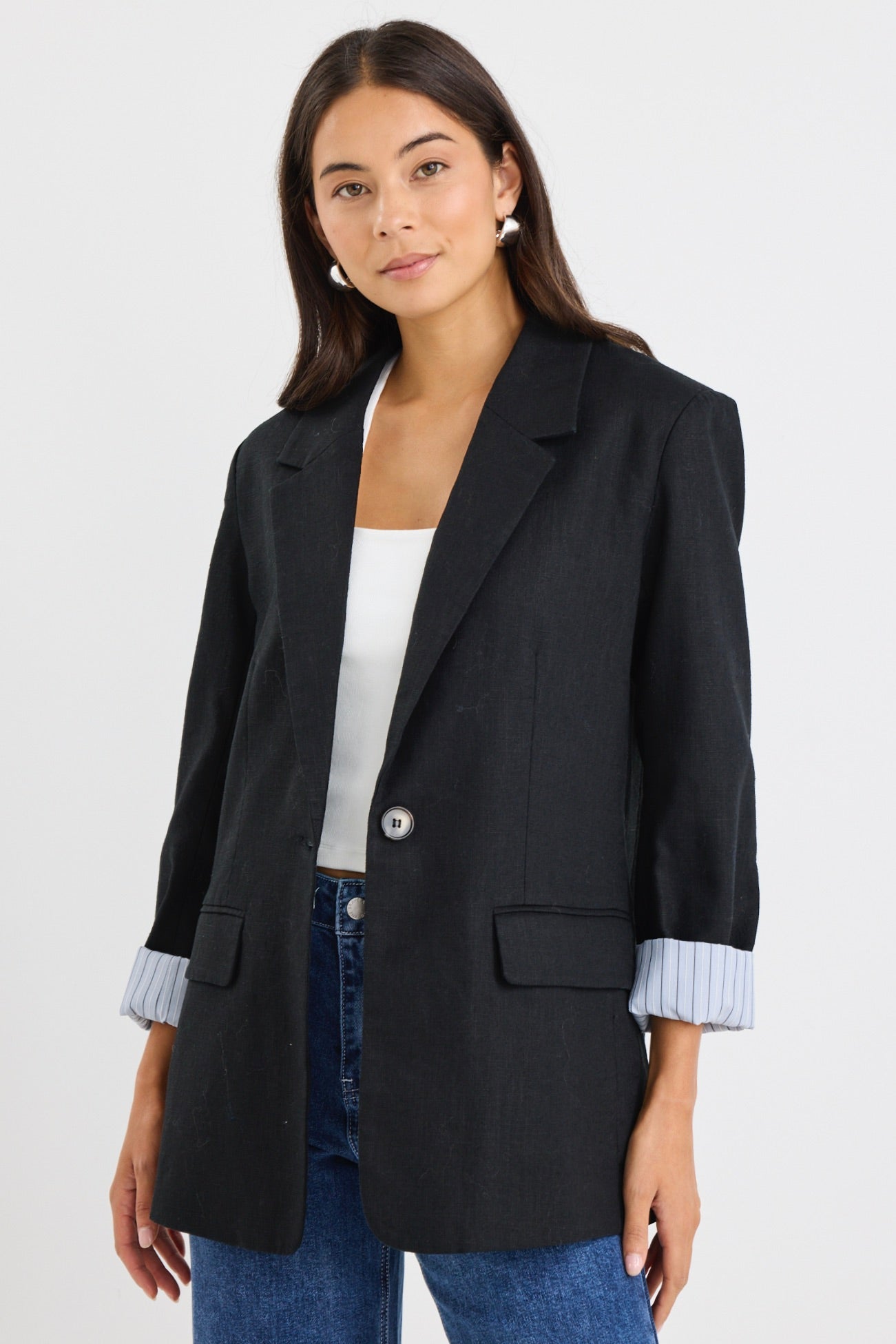 model wears a black linen blazer with blue stripe lining
